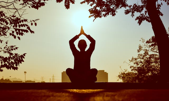 Silhouette of woman meditating